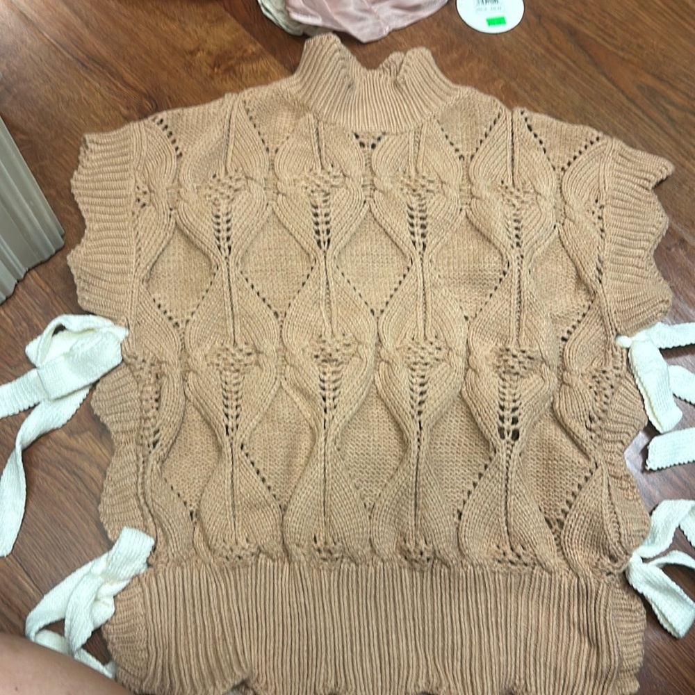 Tan sweater top with bows on side